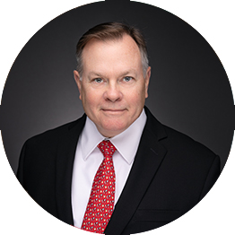 Photo of Darrell R. Caudill, Jr. in front of a bookshelf.