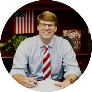 Photo of Whit Frost at a desk.